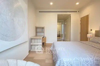 Modern bedroom with stylish decor and natural light, featuring a cozy bed and elegant furnishings.