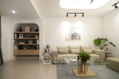 Modern living room with cozy beige sofa, stylish decor, and indoor plants creating a welcoming ambiance.