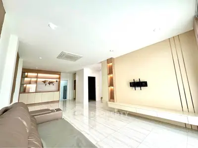 Spacious modern living room with sleek design and built-in storage