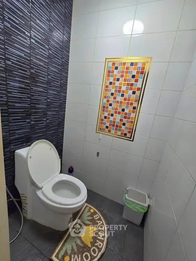 Modern bathroom with stylish tile design and cozy decor