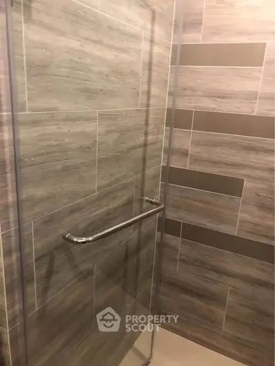 Modern bathroom with sleek tile design and glass shower enclosure