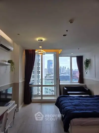 Modern bedroom with city view, featuring stylish decor and natural light, perfect for urban living.