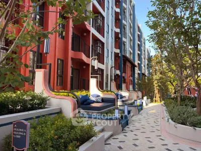 Luxurious apartment complex with stylish outdoor seating and lush greenery