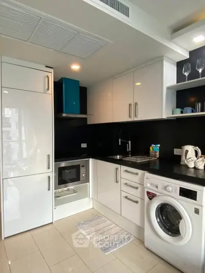 Modern kitchen with sleek white cabinets and built-in appliances