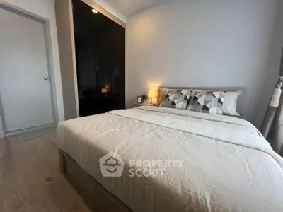 Cozy modern bedroom with stylish decor and ample natural light