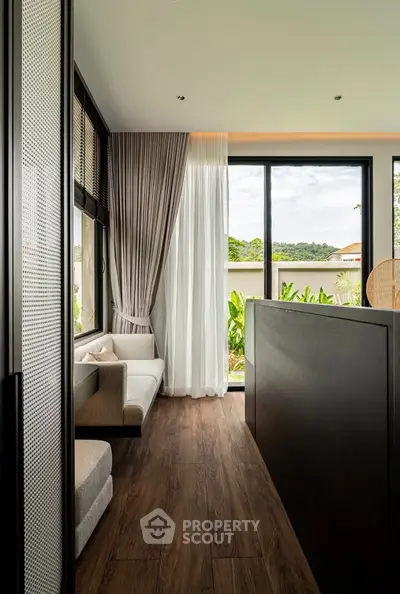 Modern living room with large windows and elegant curtains, offering a serene garden view.