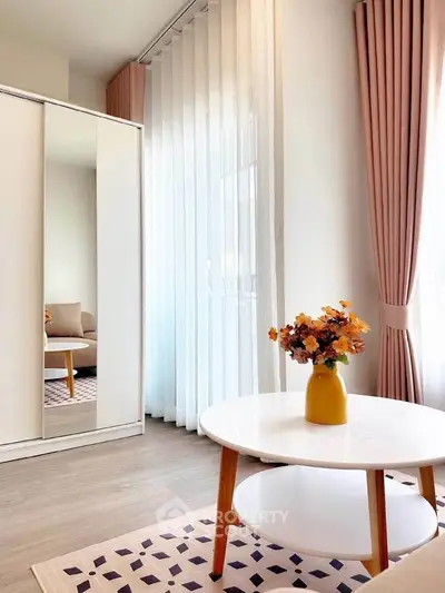 Chic living room with modern decor, featuring a stylish coffee table and elegant curtains.