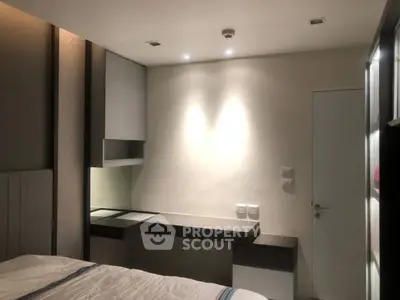 Modern bedroom with sleek built-in desk and ambient lighting