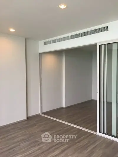 Spacious modern interior with sliding glass doors and wooden flooring