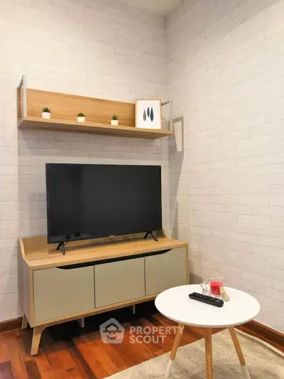 Cozy living room corner with modern TV stand and wall shelf, perfect for relaxation.