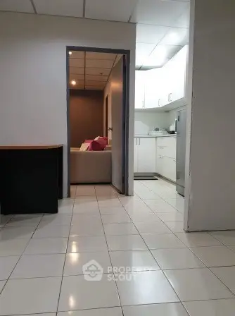 Spacious tiled interior with modern kitchen and cozy living area, perfect for comfortable living.