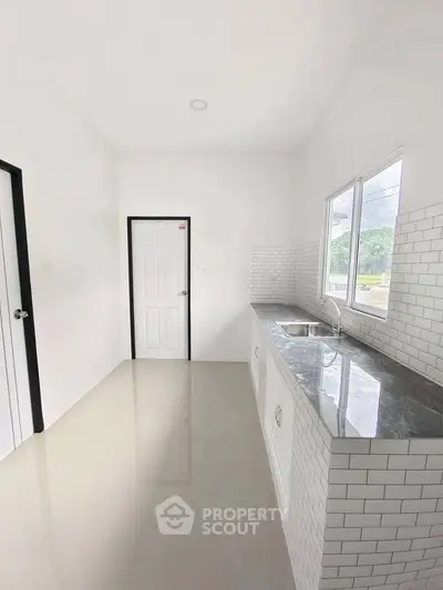 Modern kitchen with sleek countertops and white subway tiles