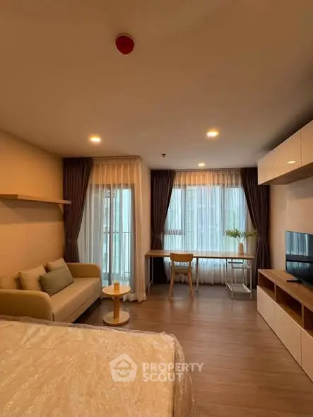 Modern studio apartment with cozy living area and stylish decor