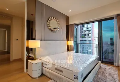 Luxurious bedroom with modern decor and city view from large windows