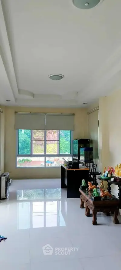 Spacious living room with large windows and elegant decor