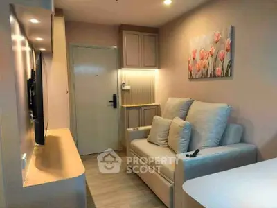 Cozy living room with modern decor and soft lighting, featuring a comfortable sofa and wall-mounted TV.