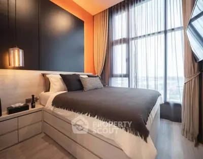 Modern bedroom with large windows and stylish decor in a high-rise apartment.