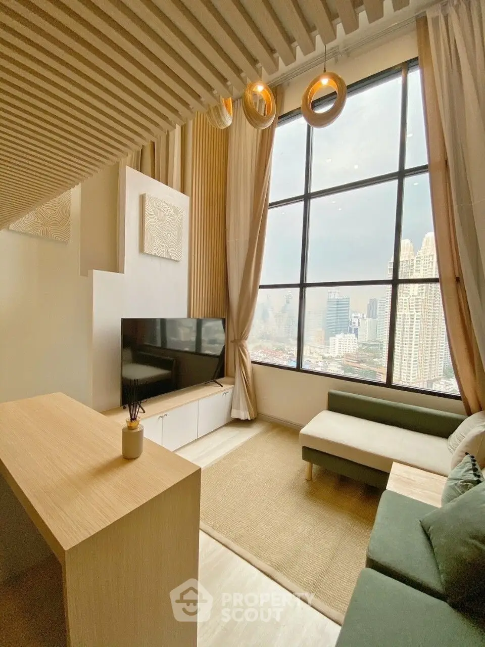 Modern living room with high ceilings and stunning city view through large windows.