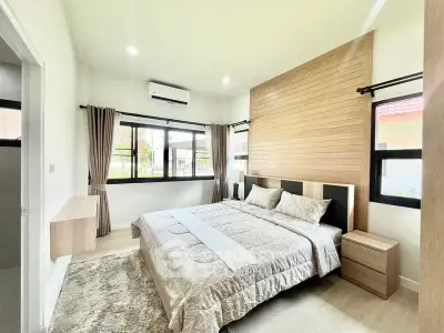 Spacious modern bedroom with large windows and elegant decor