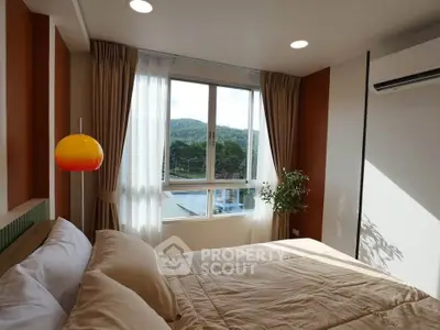 Cozy bedroom with scenic view, featuring modern decor and ample natural light.