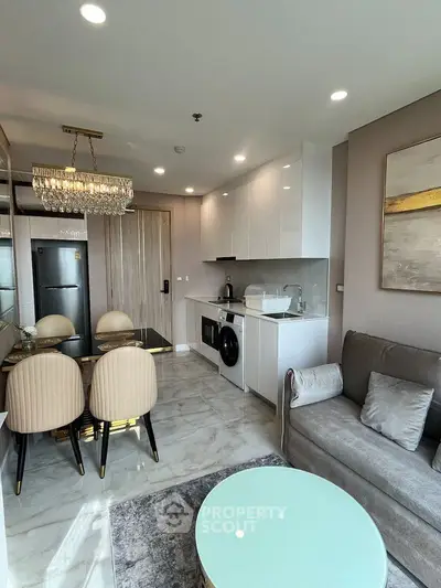 Modern open-plan living room with elegant dining area and compact kitchen