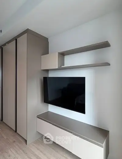 Modern living room with sleek TV setup and storage cabinets