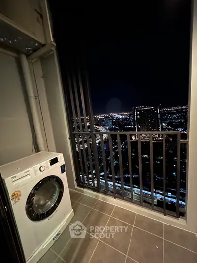 High-rise balcony with stunning city night view and washing machine