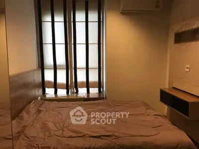 Cozy bedroom with modern design and natural light through stylish window shades.