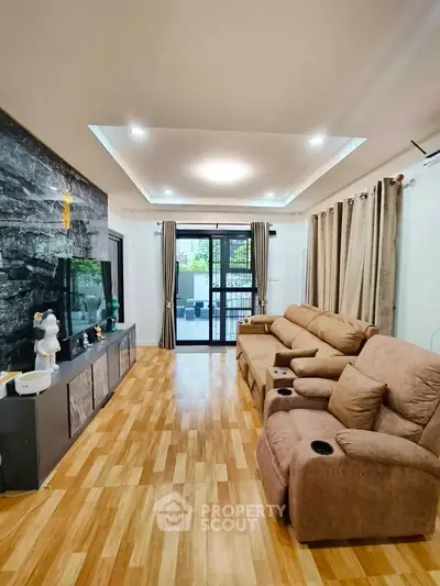Spacious living room with modern decor and large windows for natural light.