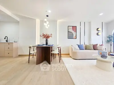 Modern living room with stylish decor and open layout, featuring a cozy seating area and elegant dining space.