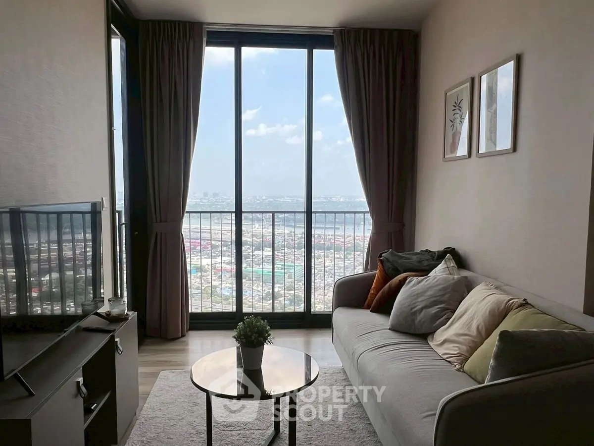 Chic living room with stunning city view, modern decor, and floor-to-ceiling windows in a high-rise apartment.
