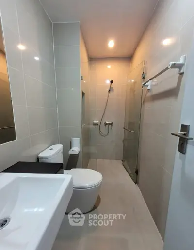 Modern bathroom with sleek fixtures and glass shower enclosure