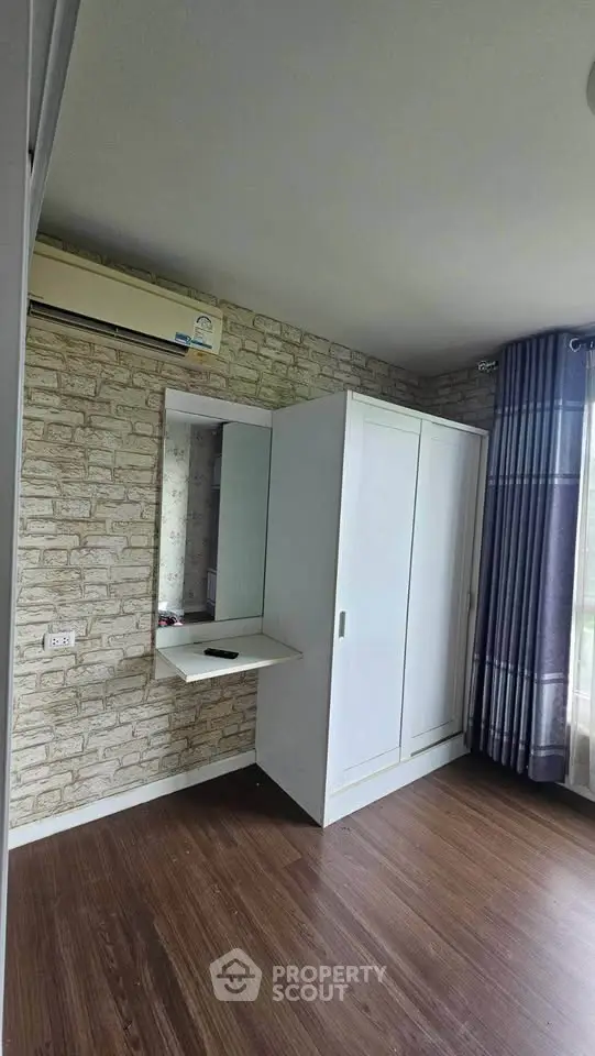 Spacious bedroom with modern wardrobe and natural light