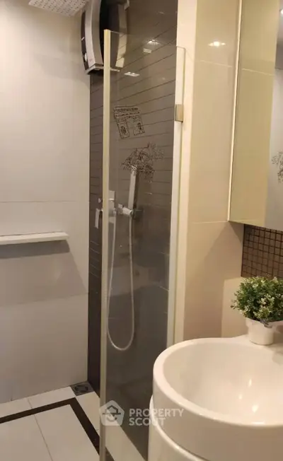 Modern bathroom with glass shower and stylish sink