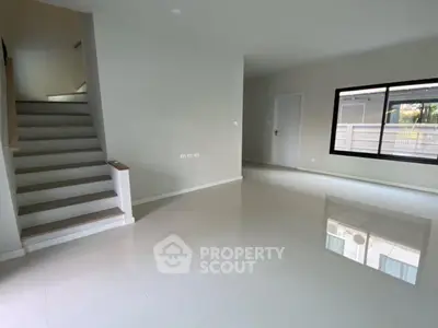 Spacious modern living room with glossy tiled floor and large window