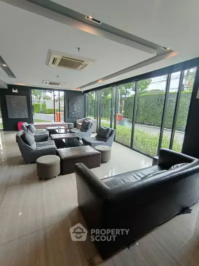 Spacious modern living room with large windows and stylish furniture