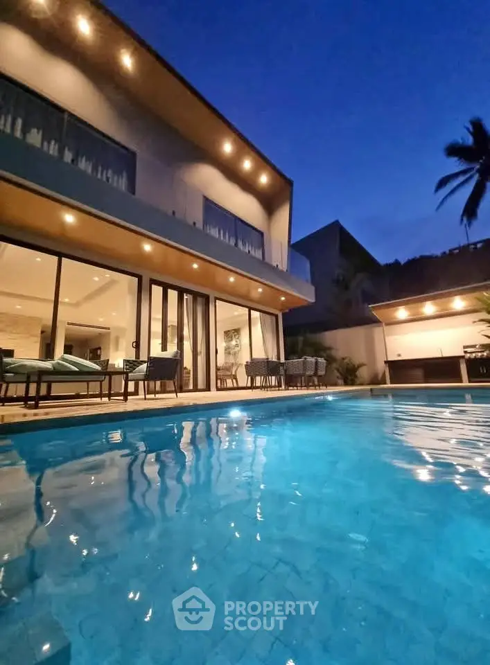Luxurious modern villa with stunning pool and ambient evening lighting.