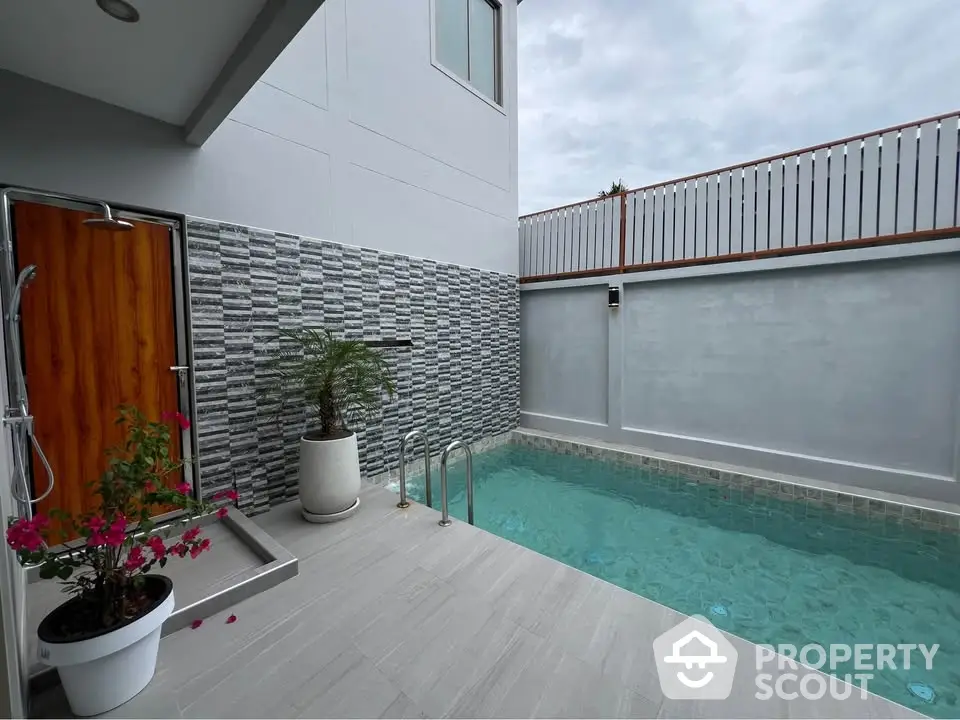 Modern private pool area with stylish design and wooden accents