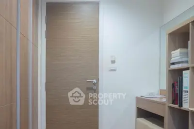 Modern study room with wooden door and built-in shelves