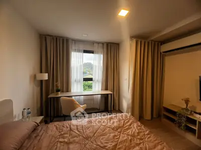 Cozy bedroom with mountain view, featuring a desk and modern decor.