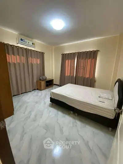 Spacious bedroom with modern decor and ample natural light