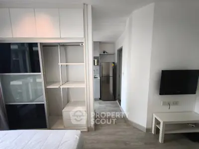 Modern studio apartment with sleek storage and compact kitchen