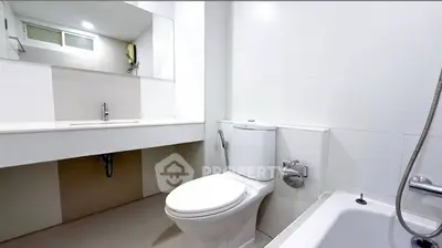 Modern bathroom with sleek fixtures and a bathtub in a bright, clean space.