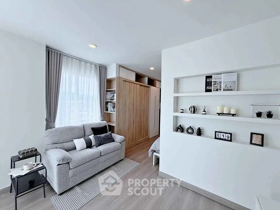 Modern living room with cozy sofa and stylish decor in a bright apartment.