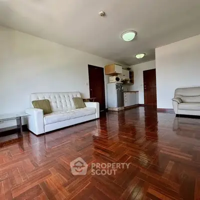 Spacious living room with wooden flooring and modern furniture