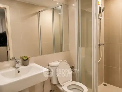 Modern bathroom with sleek shower and elegant fixtures in a contemporary apartment.