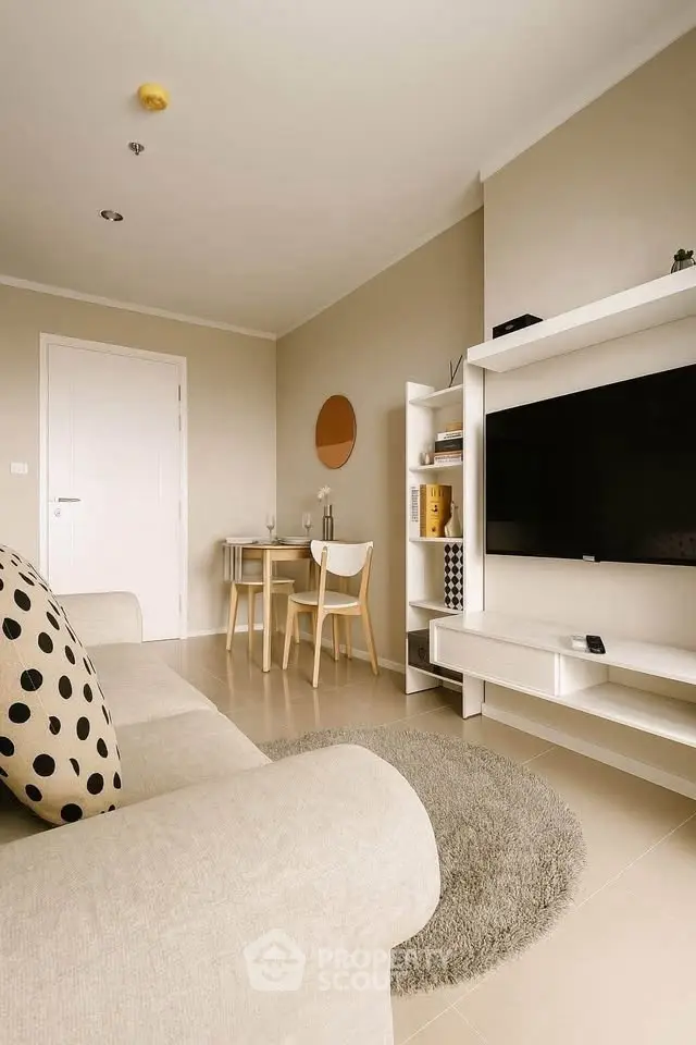 Modern living room with beige sofa, stylish TV unit, and cozy dining area.