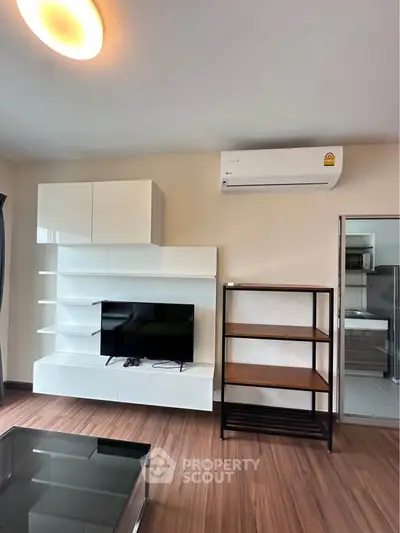 Modern living room with sleek furniture and air conditioning, perfect for comfortable living.