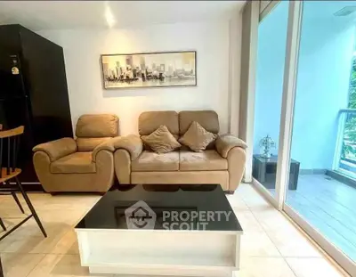Modern living room with cozy sofa and balcony view, perfect for relaxation and entertaining.