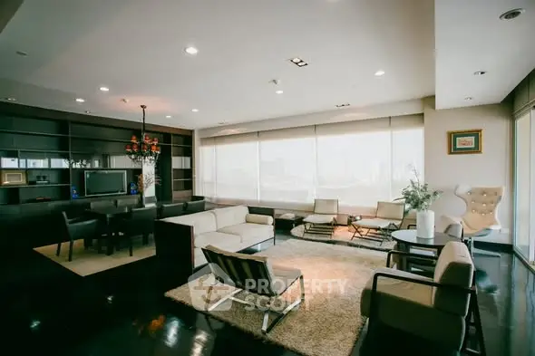 Luxurious modern living room with elegant furniture and panoramic city view.